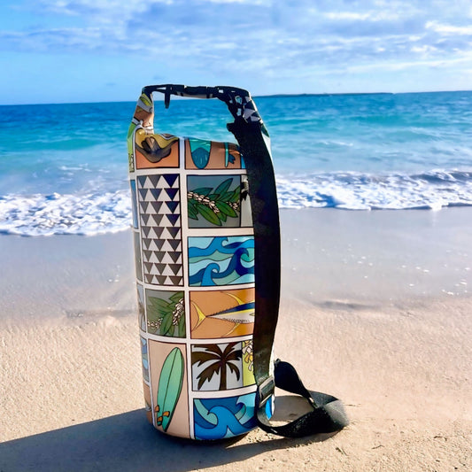 Decorative dry bag with tropical patterns on a sandy beach with ocean in the background